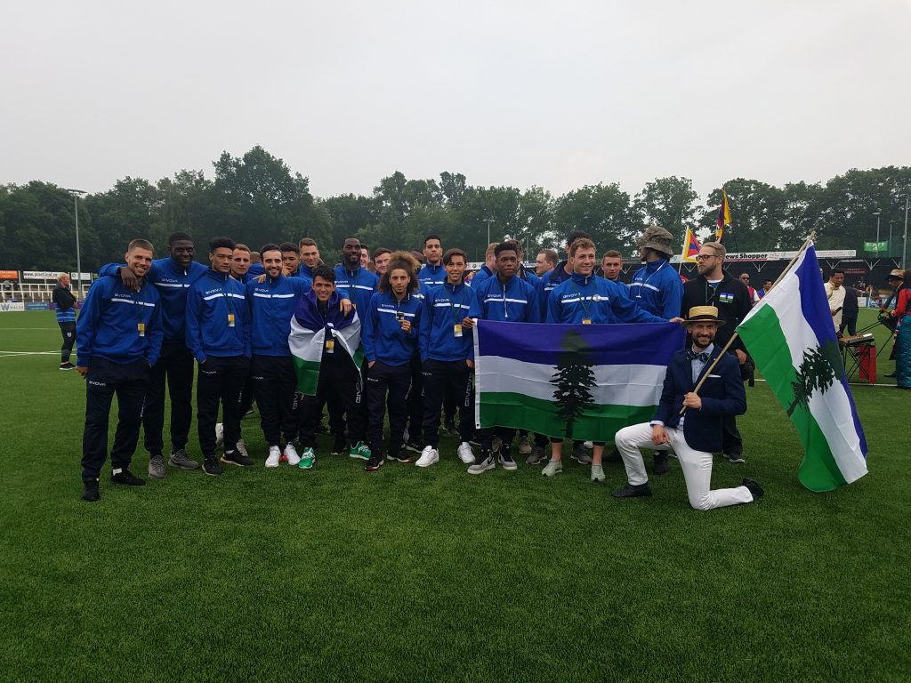 Team Cascadia huddled together after marching in the opening ceremonies of the CONIFA World Football Cup 2018. Absent are the Team Cascadia coaches.