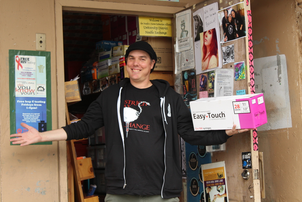  People's Harm Reduction Alliance (PHRA) Director Shilo Jama welcomes all in need to the U-district needle exchange. August 31st is International Overdose Awareness day and PHRA will be expanding services from five to six days a week, providing free Narcan/Naloxone training and hosting a memorial open for anyone to contribute.&nbsp; 